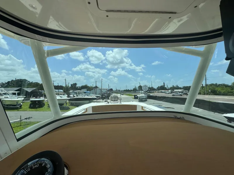 Slide: The Image of View from 2019 World Cat 3200 boat cockpit, overlooking marina with multiple boats under a blue sky. - 22