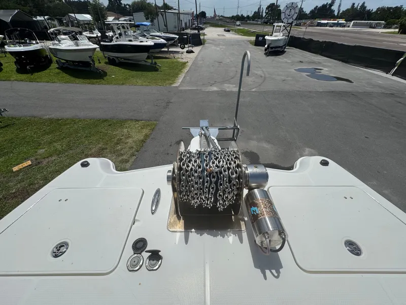 Slide: The Image of 2019 World Cat 3200 boat with anchor chain, docked among other boats. - 25