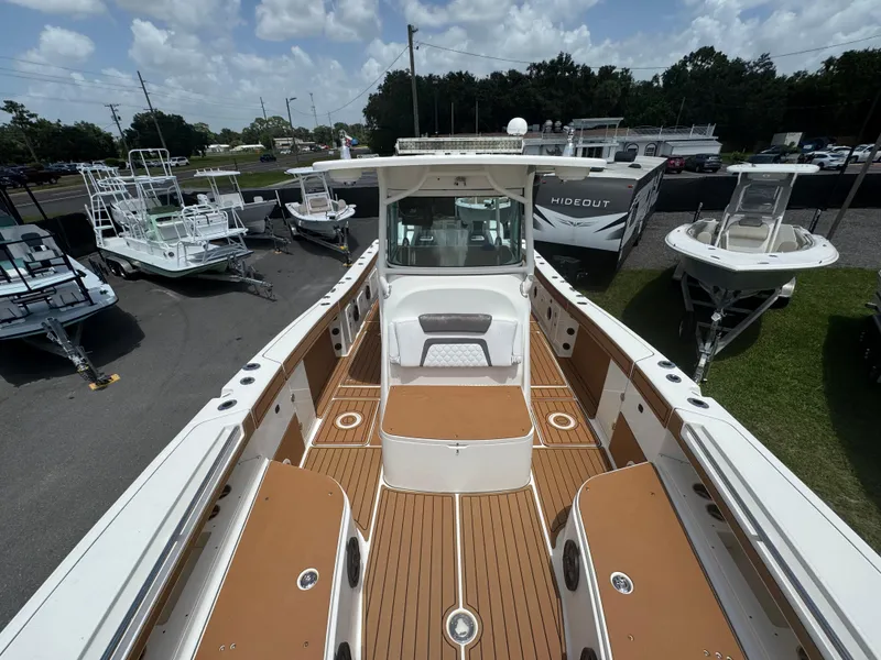 Slide: The Image of 2019 World Cat 3200 boat with spacious deck, surrounded by other boats and trailers. - 27