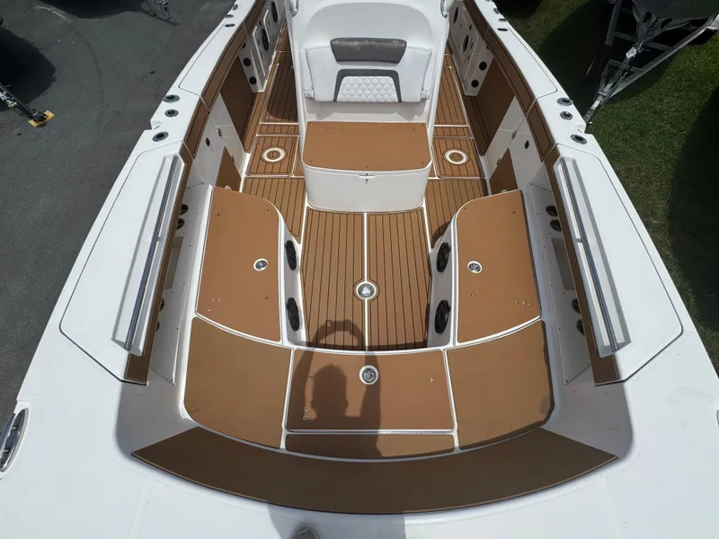 Slide: The Image of 2019 World Cat 3200 boat interior with brown and white seating and deck. - 28