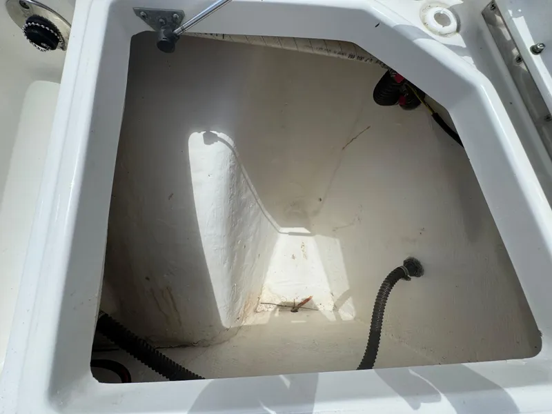 Slide: The Image of Open storage compartment in a 2019 World Cat 3200 boat, showing interior details. - 32