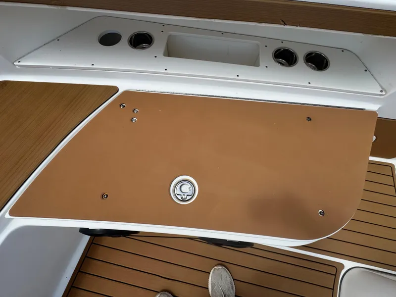 Slide: The Image of 2019 World Cat 3200 boat deck with storage compartment and wood finish. - 35