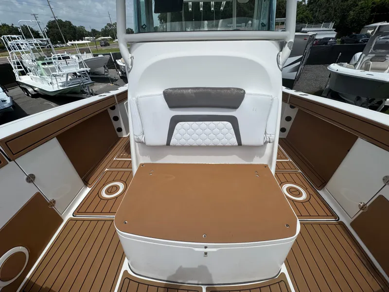 Slide: The Image of 2019 World Cat 3200 boat interior with brown and white seating and deck. - 39