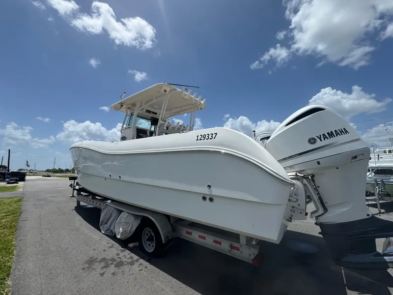 Slide: The Image of 2019 World Cat 3200 boat on trailer with Yamaha engines under a clear blue sky. - 4