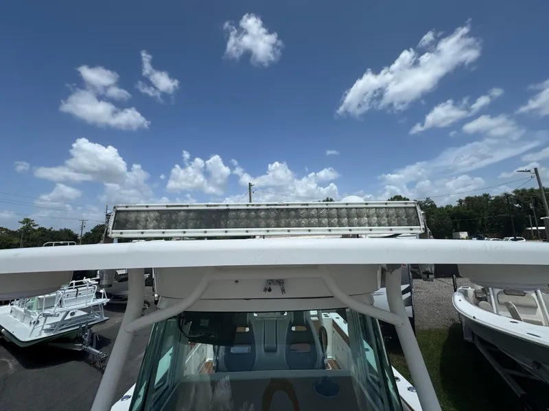 Slide: The Image of 2019 World Cat 3200 boat with a light bar under a clear blue sky. - 42