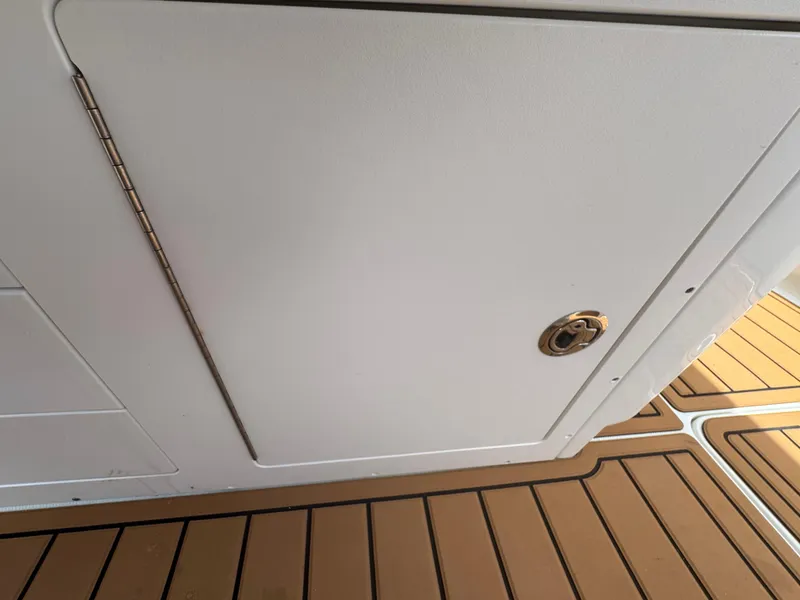Slide: The Image of 2019 World Cat 3200 boat compartment door with teak flooring. - 47