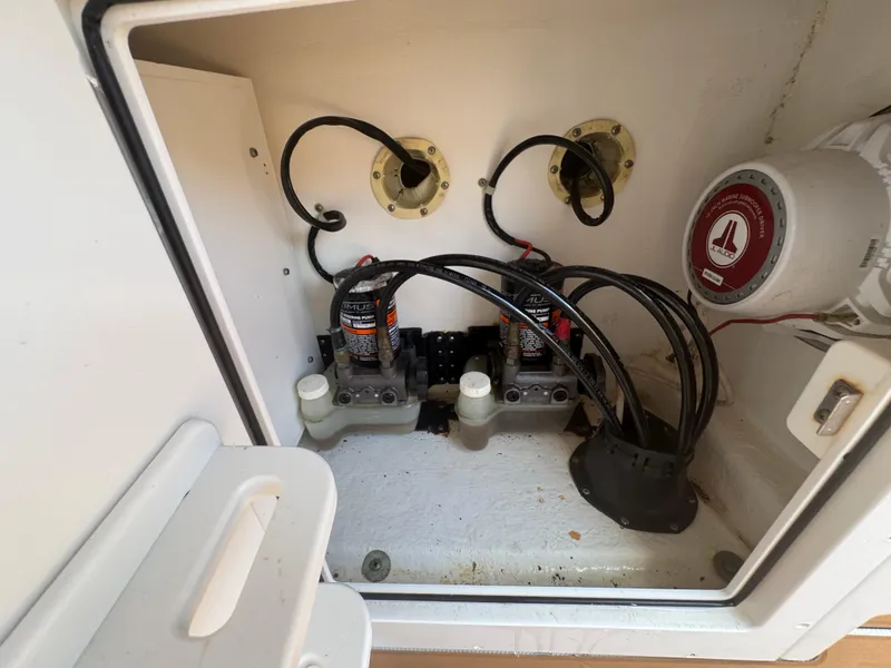 Slide: The Image of 2019 World Cat 3200 boat compartment with wiring and marine equipment. - 48