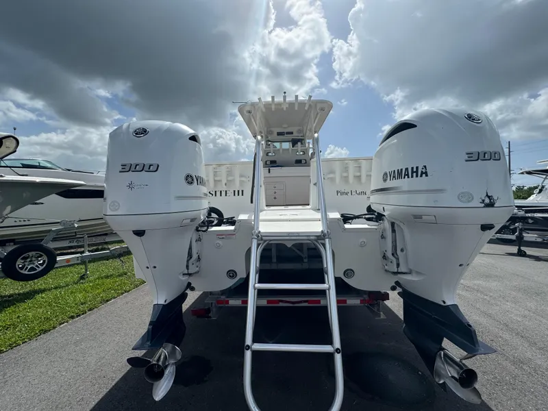 Slide: The Image of 2019 World Cat 3200 boat with twin Yamaha 300 engines, parked under cloudy sky. - 5