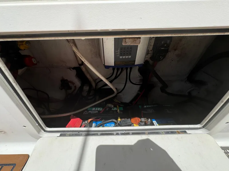 Slide: The Image of Electrical compartment of a 2019 World Cat 3200 boat, showing wiring and battery setup. - 52