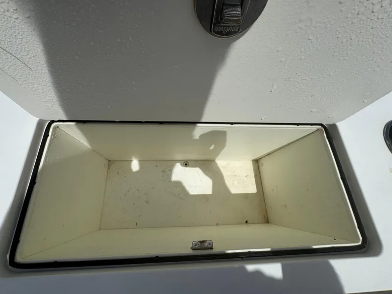 Slide: The Image of Open storage compartment on 2019 World Cat 3200 boat, showing interior space. - 56