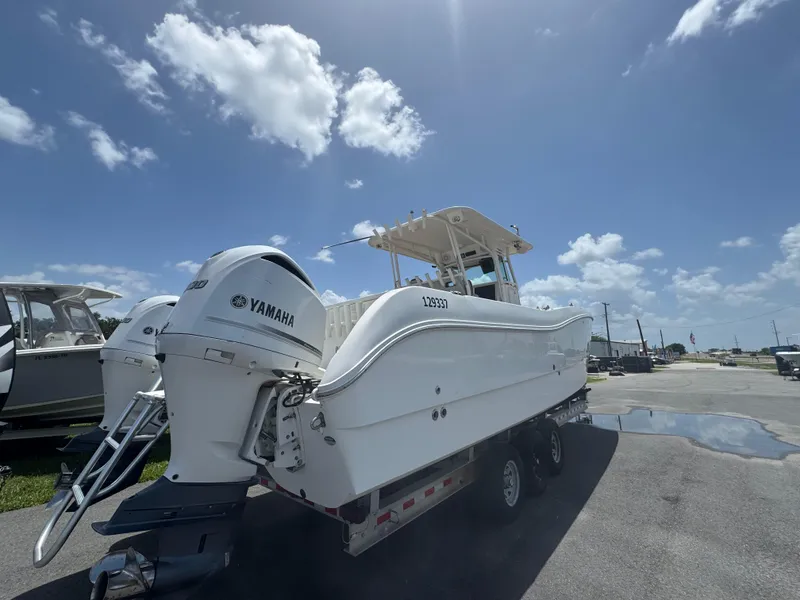 Slide: The Image of 2019 World Cat 3200 boat with Yamaha engines on a trailer under a clear blue sky. - 6