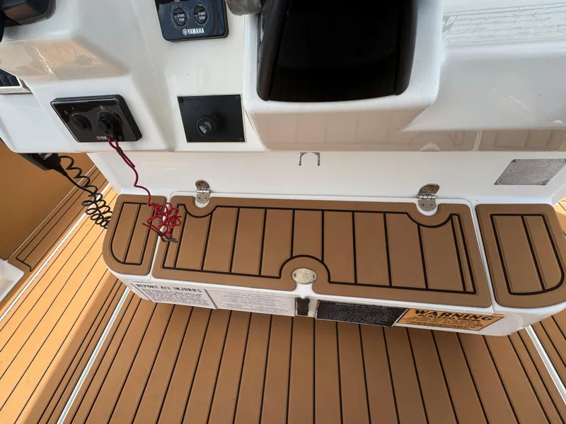Slide: The Image of 2019 World Cat 3200 boat deck with control panel and teak flooring. - 60