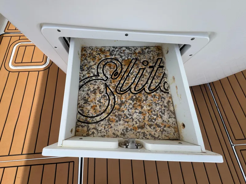 Slide: The Image of Open storage compartment on 2019 World Cat 3200 boat with "Elite" text inside. - 63