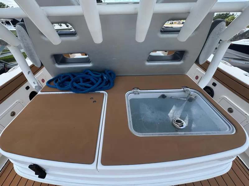 Slide: The Image of 2019 World Cat 3200 boat deck with storage and blue rope. - 67
