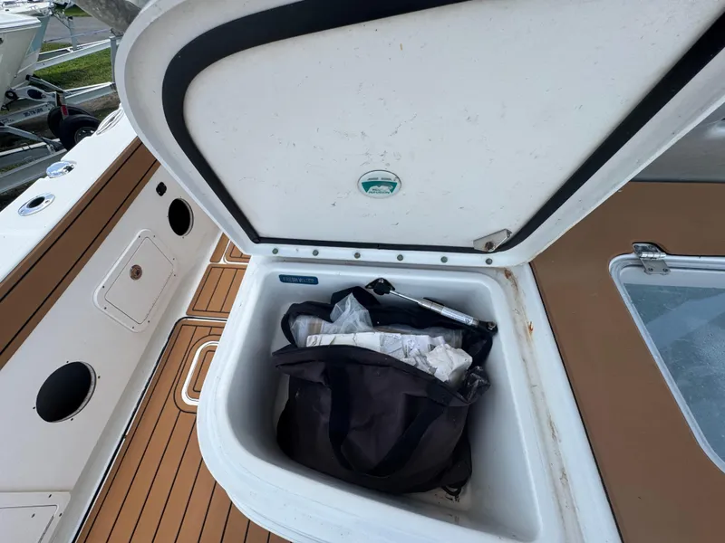 Slide: The Image of Open storage compartment on 2019 World Cat 3200 boat with bag inside. - 68