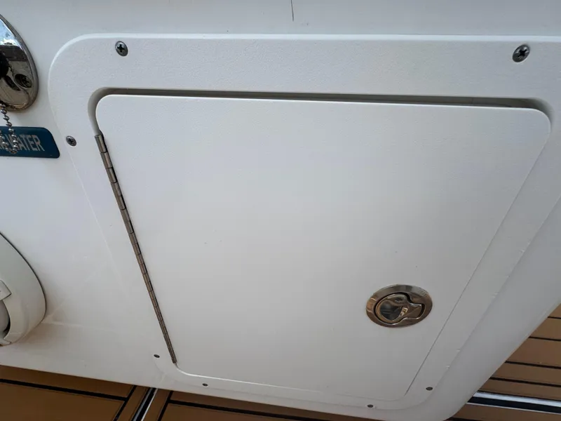 Slide: The Image of Hatch door on a 2019 World Cat 3200 boat, featuring a secure latch. - 69
