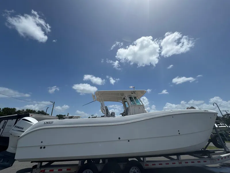 Slide: The Image of 2019 World Cat 3200 boat on trailer under clear blue sky. - 7