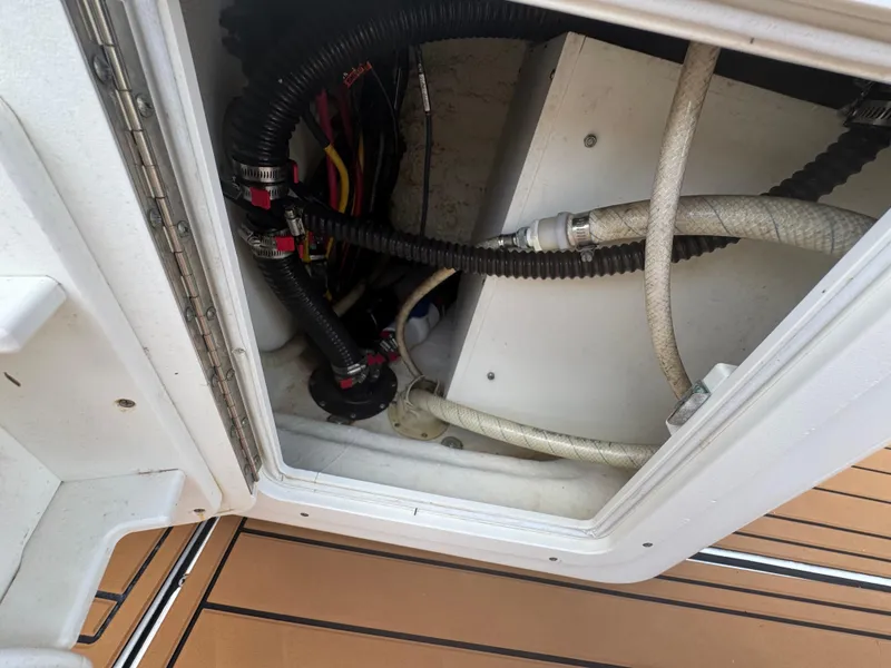 Slide: The Image of 2019 World Cat 3200 boat compartment with hoses and wiring. - 70