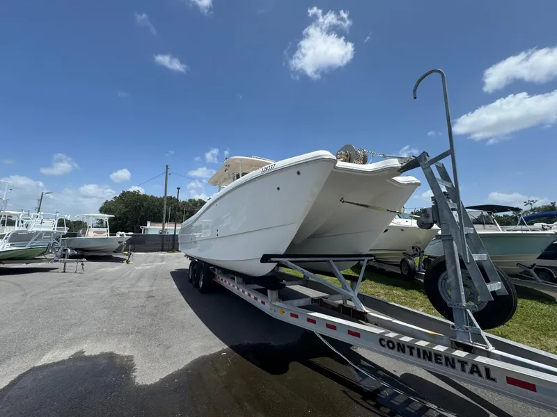 Slide: The Image of 2019 World Cat 3200 boat on trailer under clear blue sky. - 8