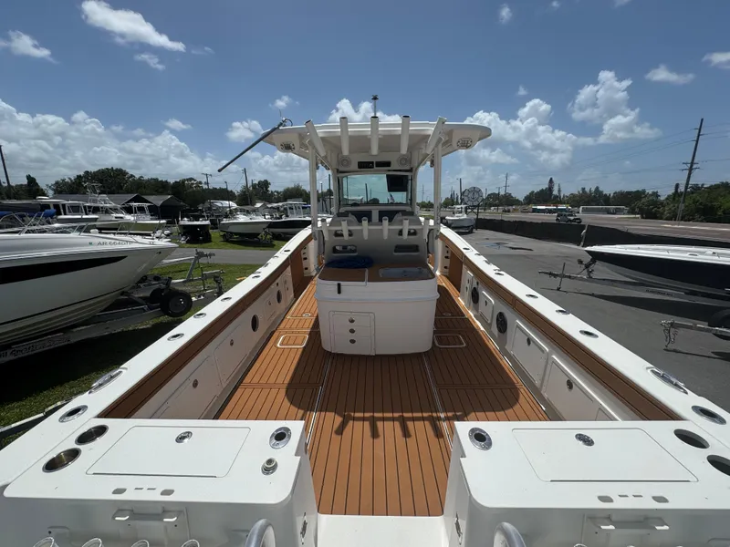 Slide: The Image of 2019 World Cat 3200 boat with spacious deck, docked under a clear blue sky. - 9