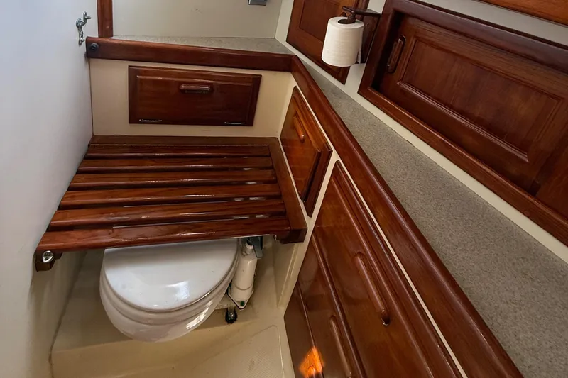 Slide: The Image of 1994 Pacific Seacraft Pilothouse 32 bathroom with wooden cabinetry and toilet. - 11