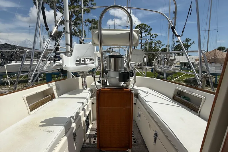 Slide: The Image of 1994 Pacific Seacraft Pilothouse 32 sailboat cockpit with seating and steering wheel. - 16