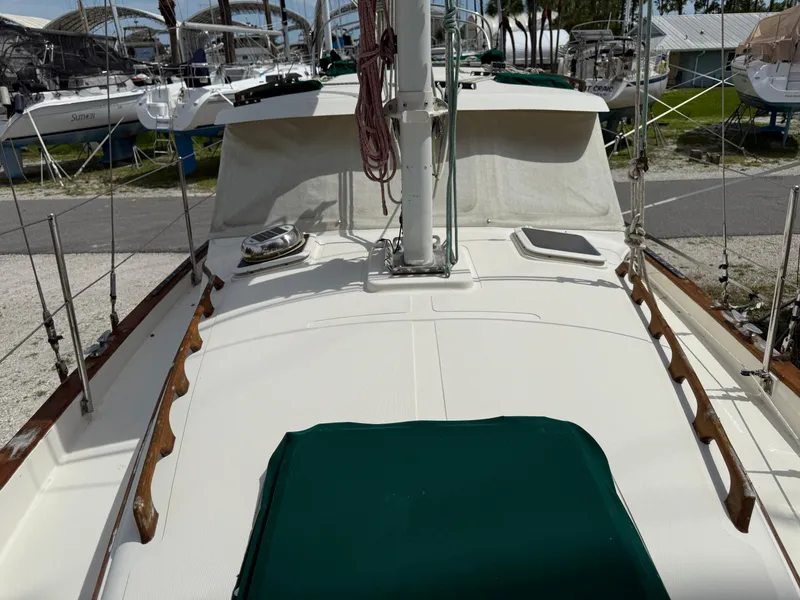 Slide: The Image of 1994 Pacific Seacraft Pilothouse 32 sailboat deck view with green covers and rigging. - 17