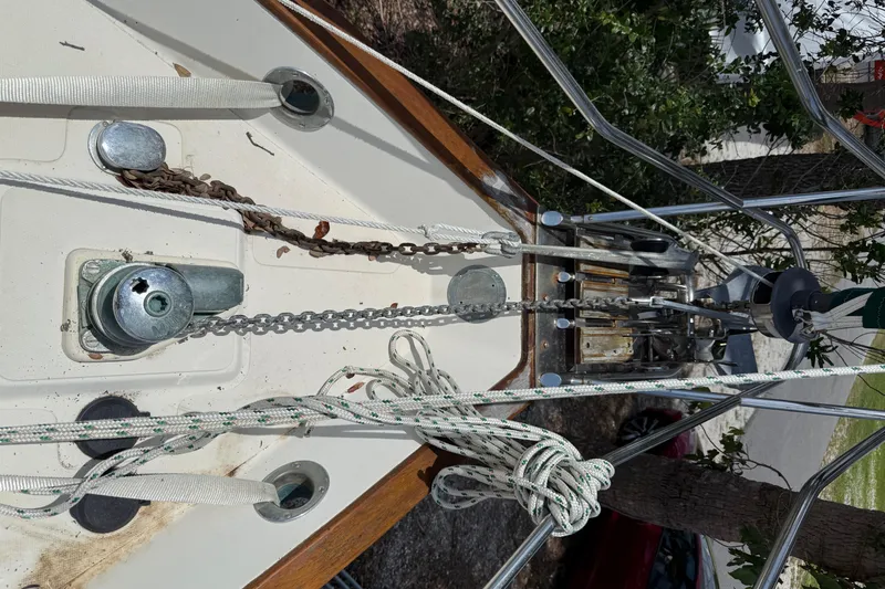 Slide: The Image of Deck view of 1994 Pacific Seacraft Pilothouse 32 sailboat with anchor chain and ropes. - 23