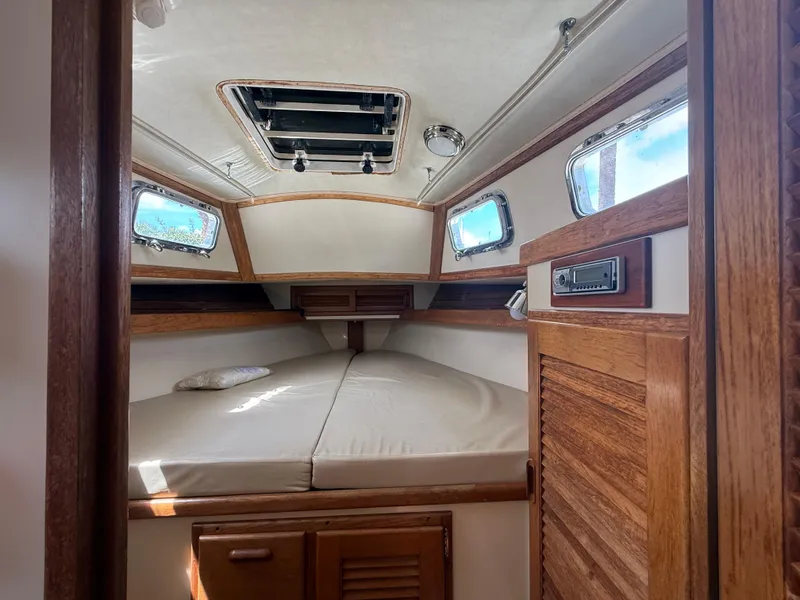 Slide: The Image of Cozy cabin interior of 1994 Pacific Seacraft Pilothouse 32 with wooden accents and natural light. - 9