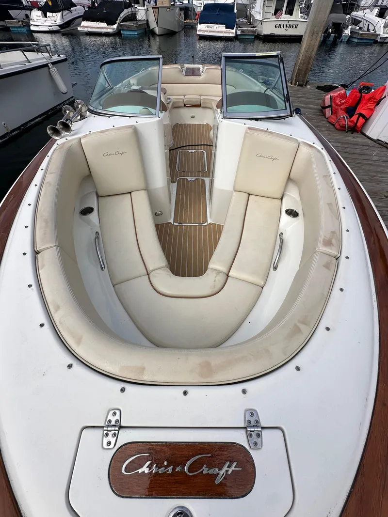Slide: The Image of 2008 Chris-Craft Launch 25 boat with beige seating, docked at a marina. - 23