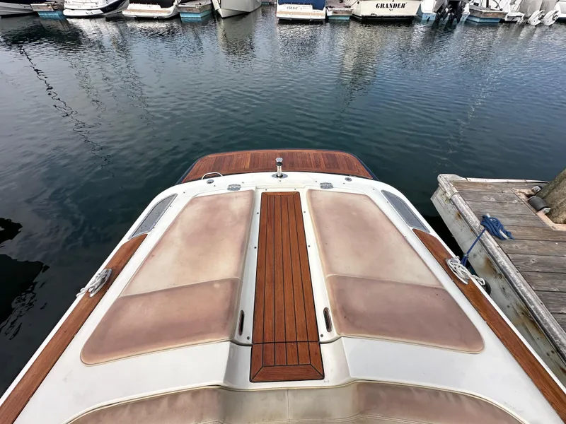 Slide: The Image of 2008 Chris-Craft Launch 25 boat docked at marina, featuring teak wood accents. - 29