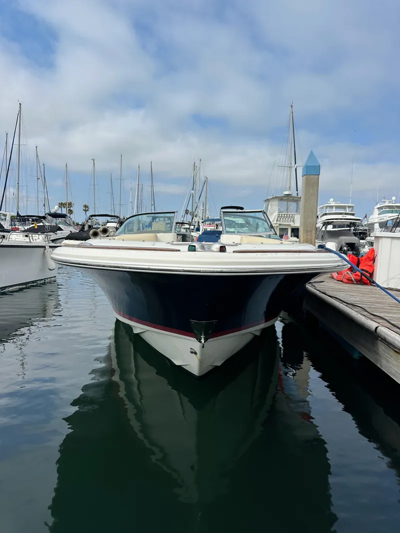 Slide: The Image of 2008 Chris-Craft Launch 25 boat docked in a marina, surrounded by other vessels. - 3
