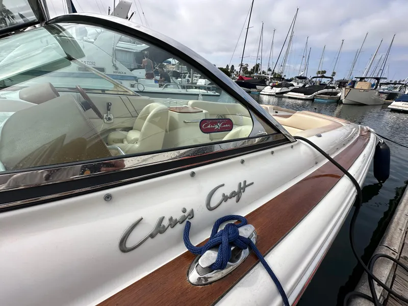 Slide: The Image of 2008 Chris-Craft Launch 25 boat docked in a marina, showcasing elegant design and craftsmanship. - 6