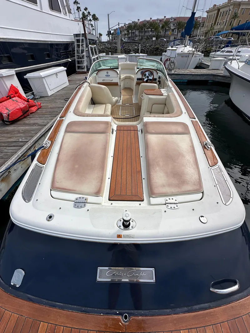 Slide: The Image of 2008 Chris-Craft Launch 25 boat docked at marina, featuring spacious seating and elegant design. - 7