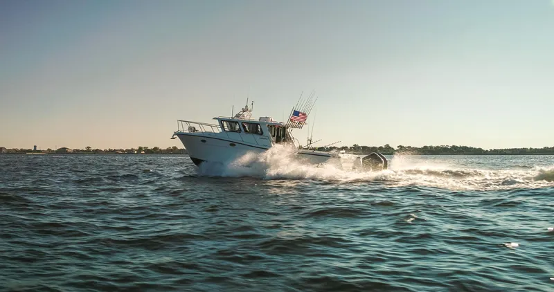Slide: The Image of 2025 Lindell 41' boat cruising on open water under clear skies. - 5