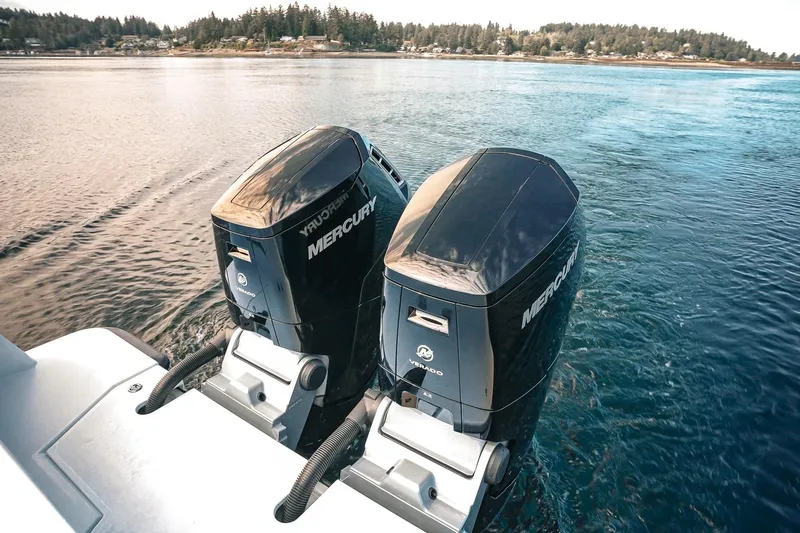 Slide: The Image of Twin Mercury outboard engines on a 2027 Lindell 41' boat, cruising in scenic waters. - 10