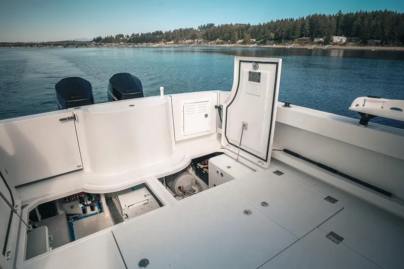Slide: The Image of Modern Lindell 41' boat deck with open compartments, 2027 model, on a serene lake. - 11