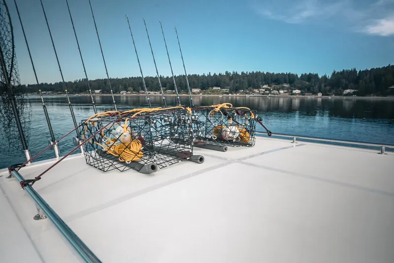 Slide: The Image of Fishing gear on Lindell 41' boat deck, 2027 model, with scenic waterfront view. - 18