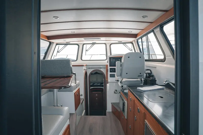 Slide: The Image of Interior of a 2027 Lindell 41' boat, featuring modern helm and galley area. - 21