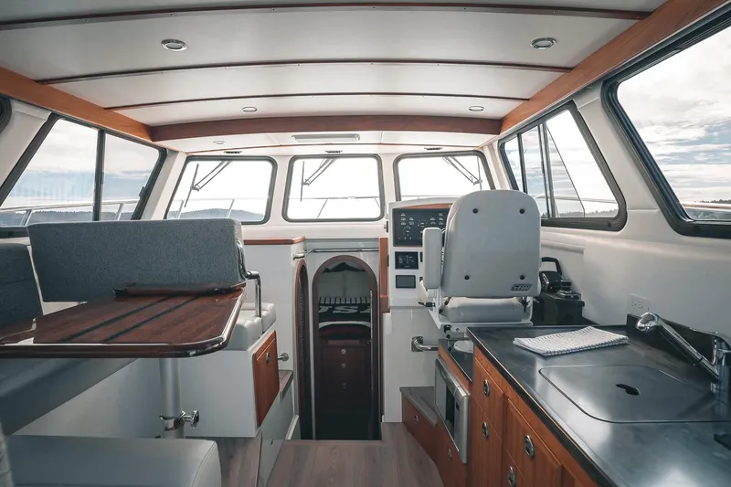 Slide: The Image of Interior of a 2027 Lindell 41' boat, featuring helm, seating, and kitchenette. - 22