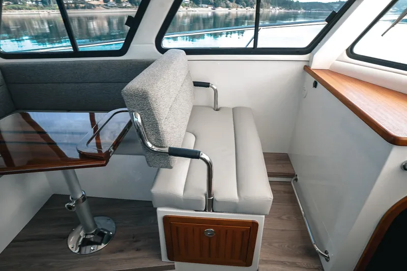 Slide: The Image of Interior of 2027 Lindell 41' boat with modern seating and wooden table. - 27