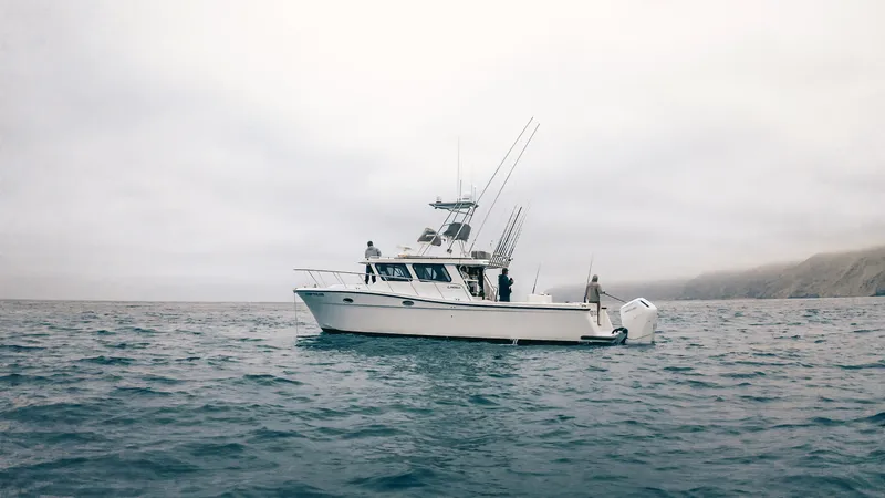 Slide: The Image of 2025 Lindell 41' boat on open water under cloudy skies. - 3