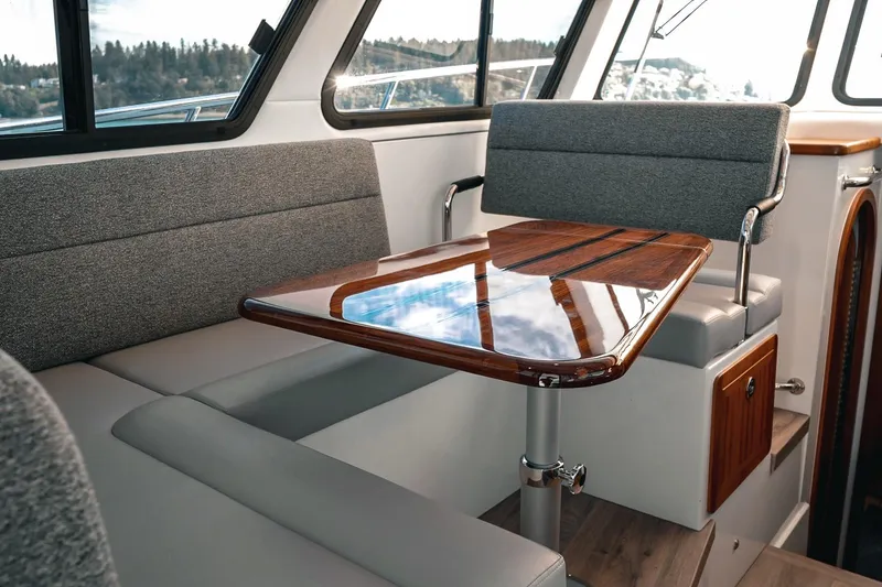 Slide: The Image of Luxurious interior of 2027 Lindell 41' yacht with elegant wood table and plush seating. - 30