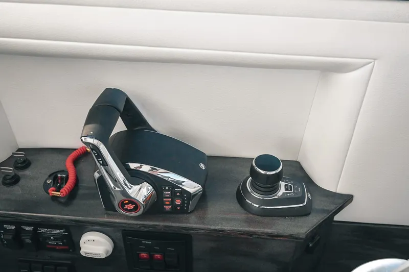 Slide: The Image of Control panel of a 2027 Lindell 41' boat with throttle and joystick. - 36