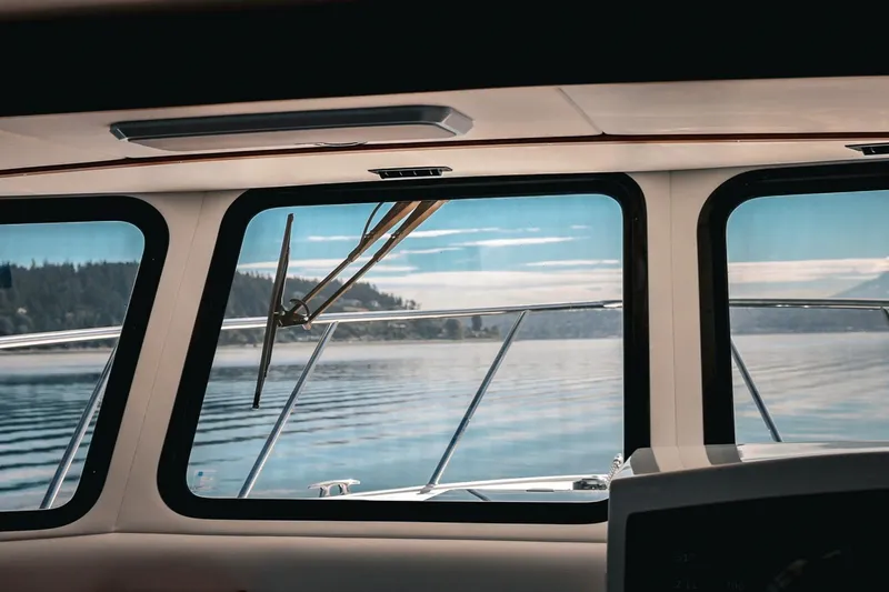 Slide: The Image of View from inside a 2027 Lindell 41' boat, overlooking serene waters and distant shoreline. - 37