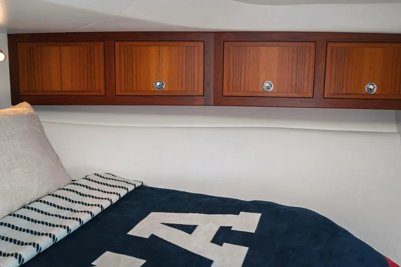 Slide: The Image of Cozy cabin interior of 2027 Lindell 41' with wooden cabinets and comfortable bedding. - 42