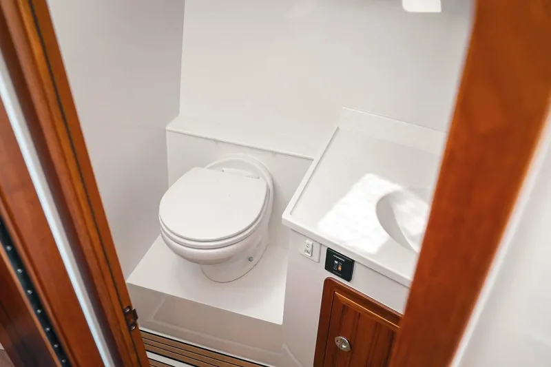 Slide: The Image of Modern bathroom interior on 2027 Lindell 41' boat, featuring toilet and sink. - 43