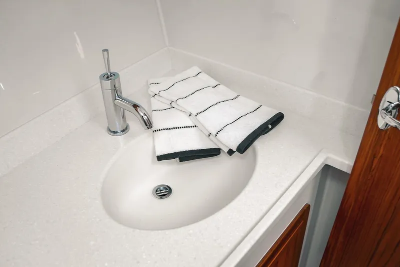 Slide: The Image of Modern bathroom sink with chrome faucet and folded towels on Lindell 41' 2027 model. - 46