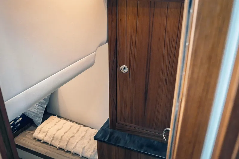 Slide: The Image of Interior cabin of 2027 Lindell 41' boat with wooden cabinetry and cozy bedding. - 47