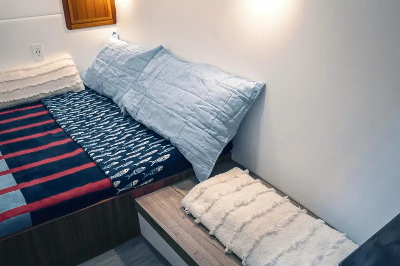 Slide: The Image of Cozy interior of 2027 Lindell 41' boat with stylish bedding and soft lighting. - 48